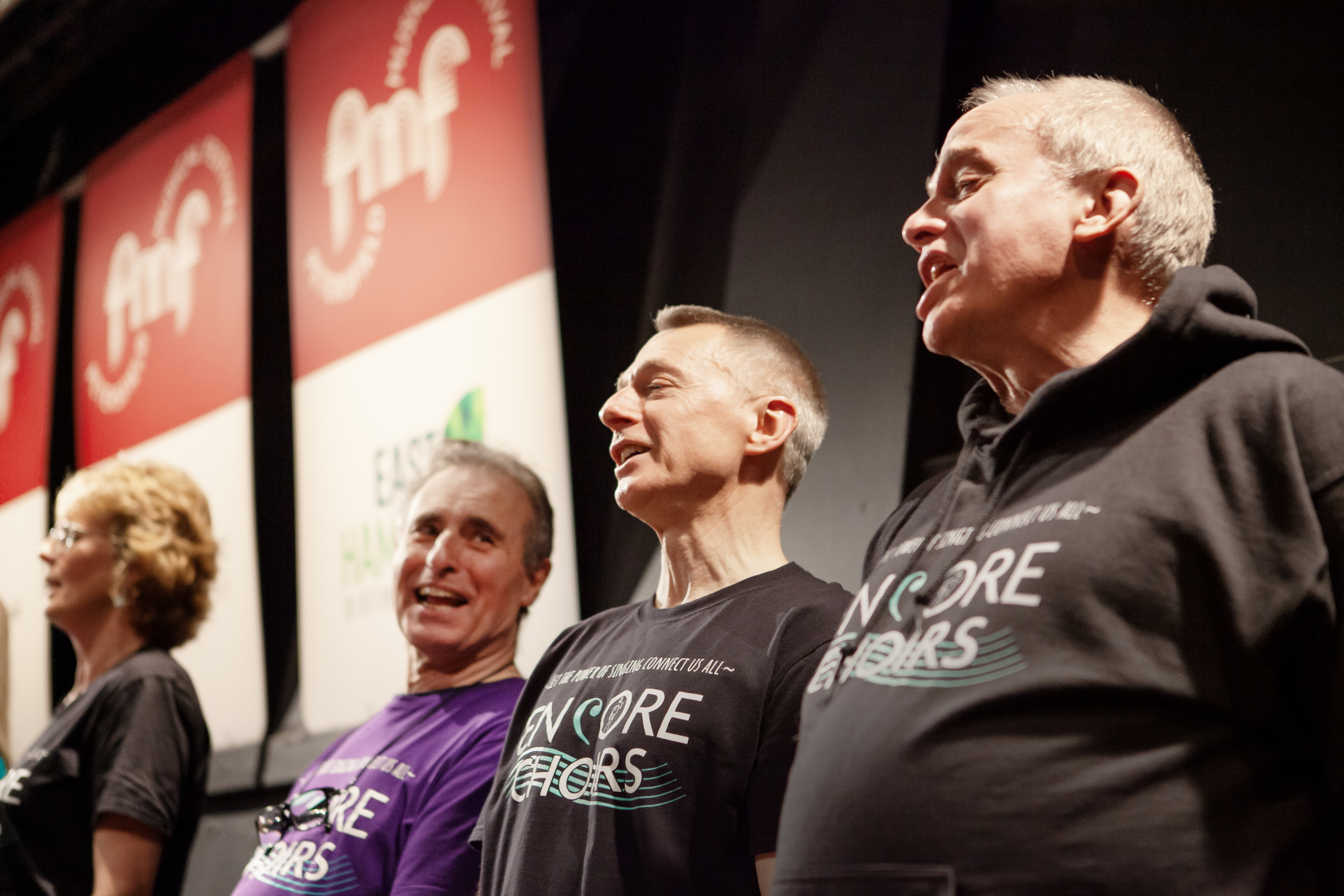 Several men singing with Encore Choirs