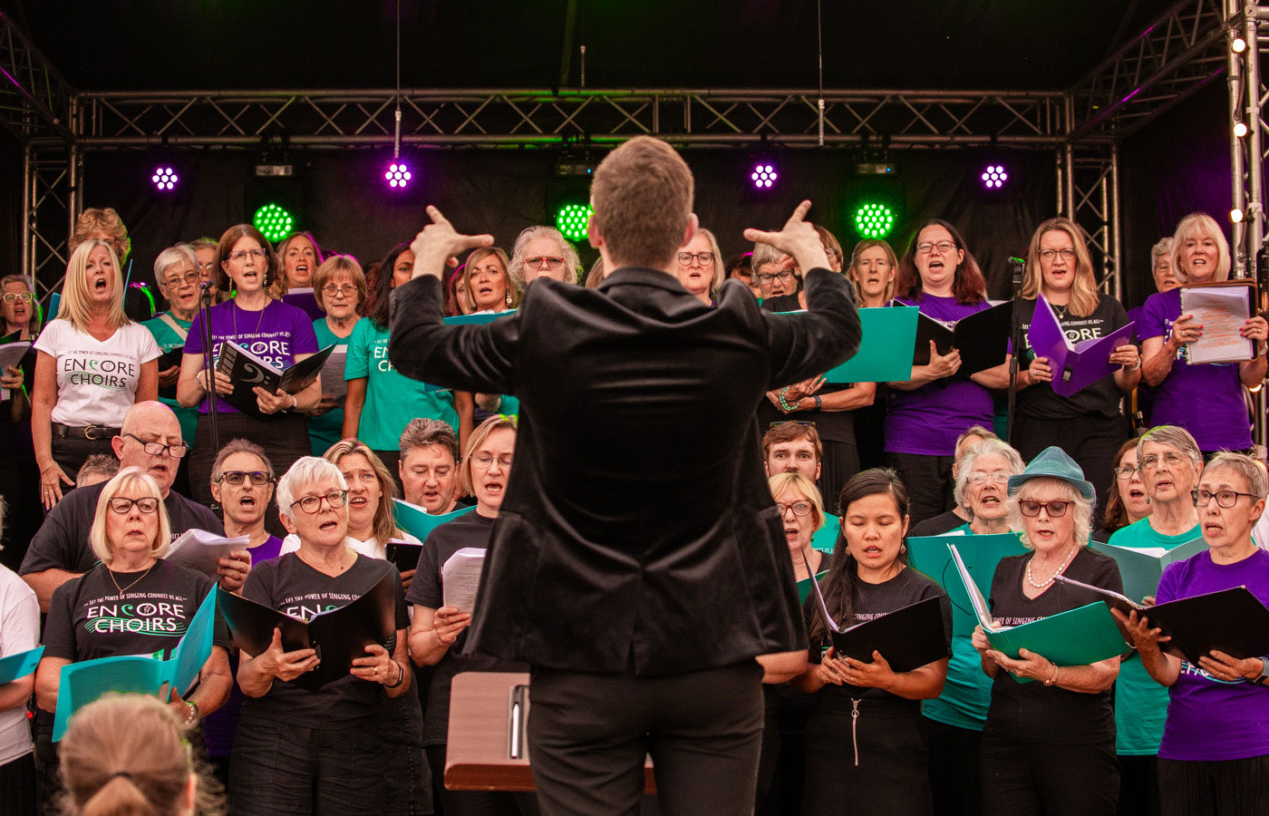 Enchoir Choir singing with conductor in front
