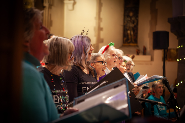 Community choir singing at a Christmas concert in a church