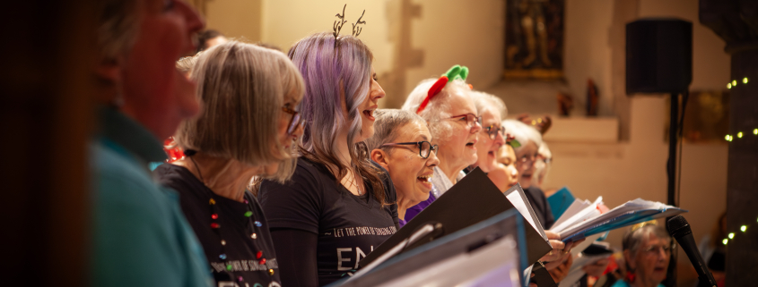 Community choir singing at a Christmas concert in a church